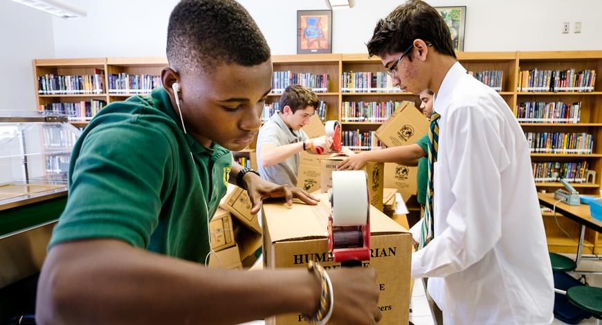 Kori Vernon and other students ready boxes to hold the meals packed of Stop Hunger Now. 